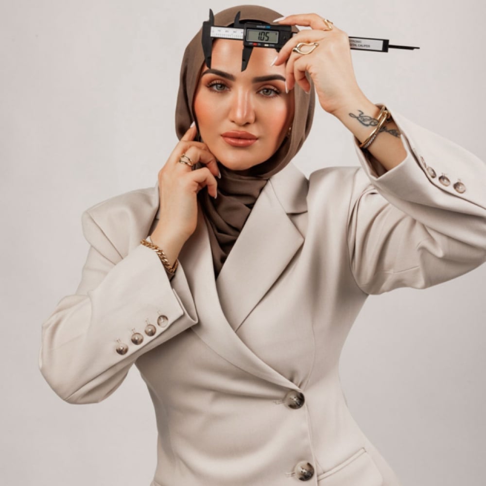 Rana Khalifa holding a brow mapping tool